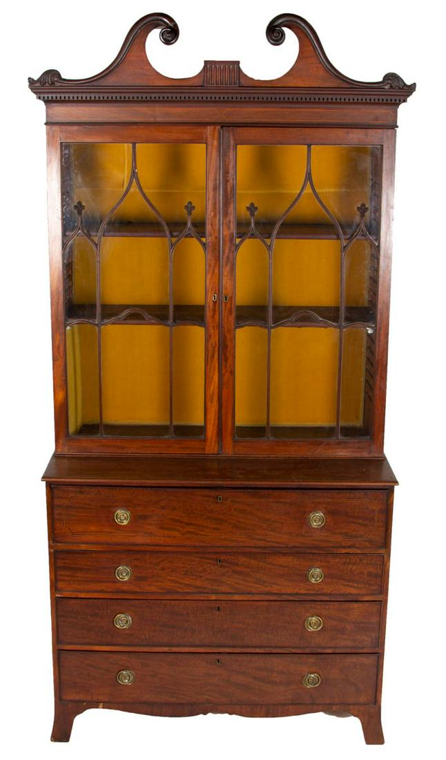 BRITISH INLAID MAHOGANY SECRETARY DESK AND BOOKCASE: BRITISH INLAID MAHOGANY SECRETARY DESK AND BOOKCASE, in three-sections, removable cornice, top featuring two hinged doors having unusual fenestration in the shape of gothic arches, lower case with des