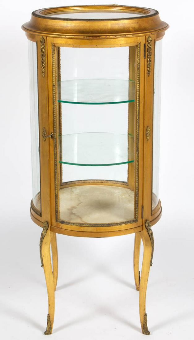 FRENCH GILTWOOD VITRINE / CURIO CABINET: FRENCH GILTWOOD VITRINE / CURIO CABINET, with applied brass ormolu decoration, interior with two glass shelves, the whole raised on shaped legs. Late 19th/early 20th century. 49 1/4" H, 18 1/2" D top.