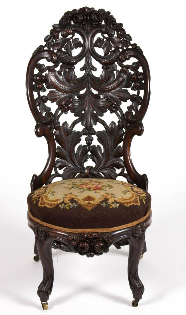 JOHN HENRY BELTER (NEW YORK, 1804-1863), ATTRIBUTED,: JOHN HENRY BELTER (NEW YORK, 1804-1863), ATTRIBUTED, CARVED ROSEWOOD LAMINATED SLIPPER CHAIR, the pierced back with foliate and acorn designs over a later upholstered seat raised on shaped legs with l