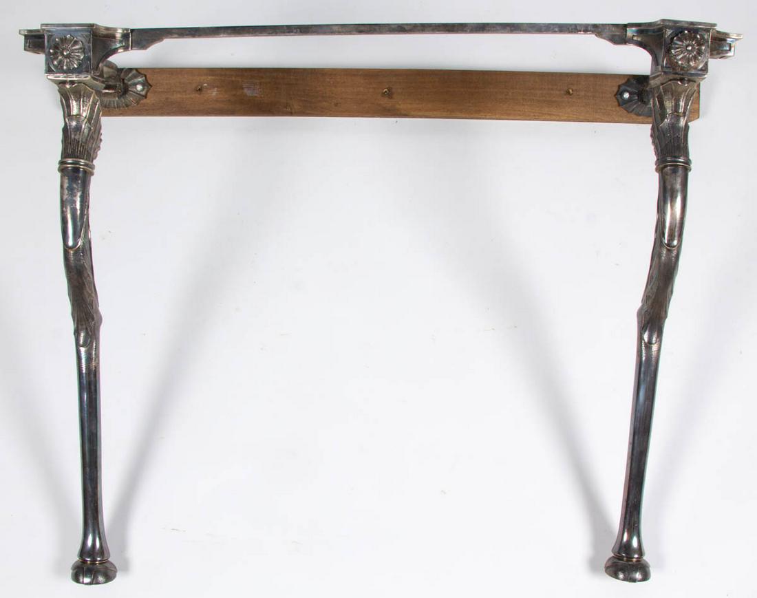 VICTORIAN CAST-METAL CONSOLE TABLE: VICTORIAN CAST-METAL CONSOLE TABLE, nickel finish featuring shell decoration and stylized hoof feet. Fourth quarter 19th century. 28" H, 35" W, 19" D. Lacking top, otherwise very good with scattered m