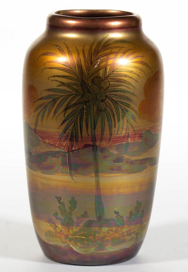 WELLER LASA ART POTTERY VASE: WELLER LASA ART POTTERY VASE, slight ovoid form, having iridescent metallic glaze featuring a sunrise/sunset behind mountains and serene water with palm trees laden with coconuts in foreground. Unmark
