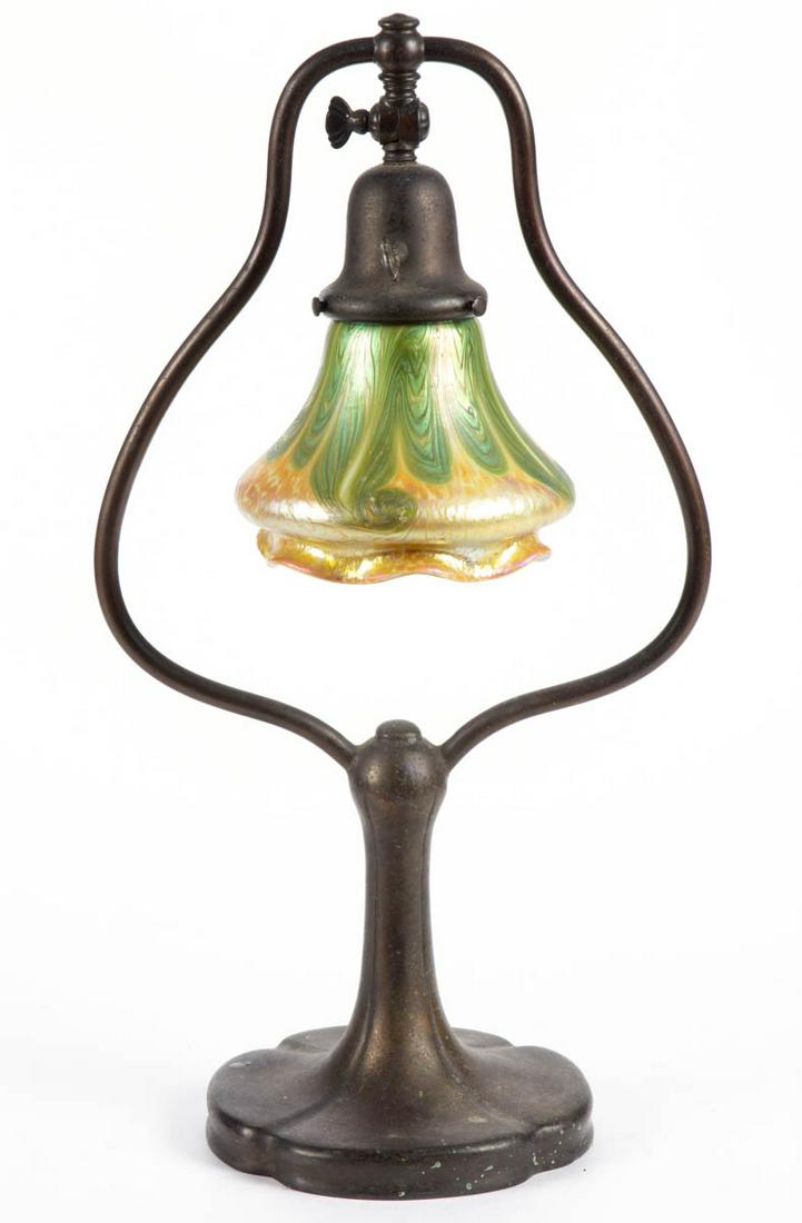 HANDEL NO. 6373 BRONZE ELECTRIC TABLE LAMP: HANDEL NO. 6373 BRONZE ELECTRIC TABLE LAMP, bronze finish, single-socket supported by a harp and a four-lobed base, retains original fabric (detached). Fitted with a gold and green iridescent pulled-d