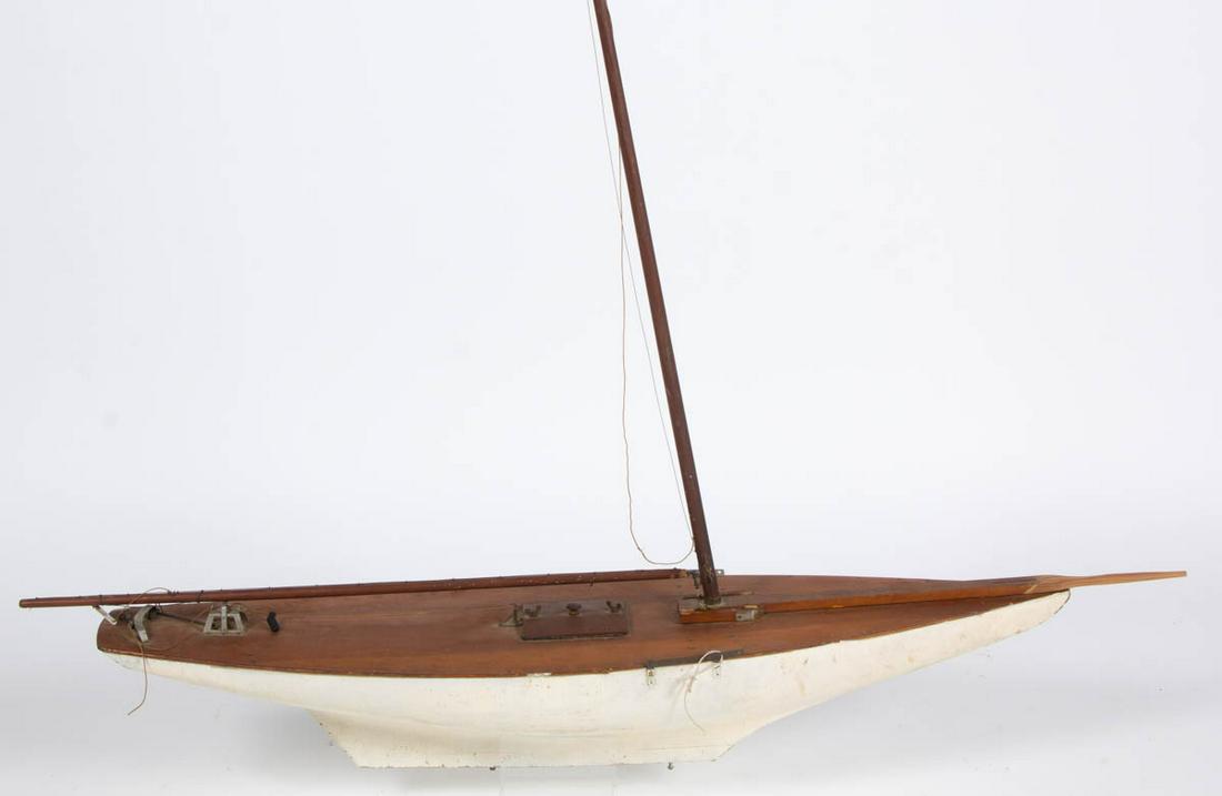 CARVED AND PAINTED SHIP MODEL / POND BOAT: CARVED AND PAINTED SHIP MODEL / POND BOAT, retains an old white-painted surface. First half 20th century. 8" H, 47" LOA.Very good overall as-found condition, possibly replaced bow, and missing pieces.