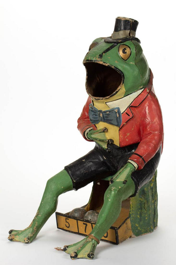 FOLK ART PAPIER-MACHE FIGURAL CARNIVAL TOSS: FOLK ART PAPIER-MACHE FIGURAL CARNIVAL TOSS, in the form of an anthropomorphized frog dressed in top hat and bowtie seated on a stump, pine base board, retains two likely original balls and the remain