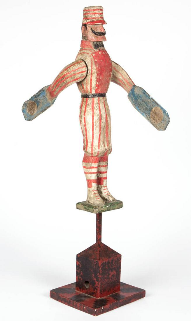 LOU SCHIFFERL (AMERICAN, B. 1931) FOLK ART CARVED AND: LOU SCHIFFERL (AMERICAN, B. 1931) FOLK ART CARVED AND PAINTED WHIRLIGIG, depicting an old time baseball player, signed to the underside of the baseball player "SCHIFFERL". Circa 1970. 31 1/2" HOA. Ver