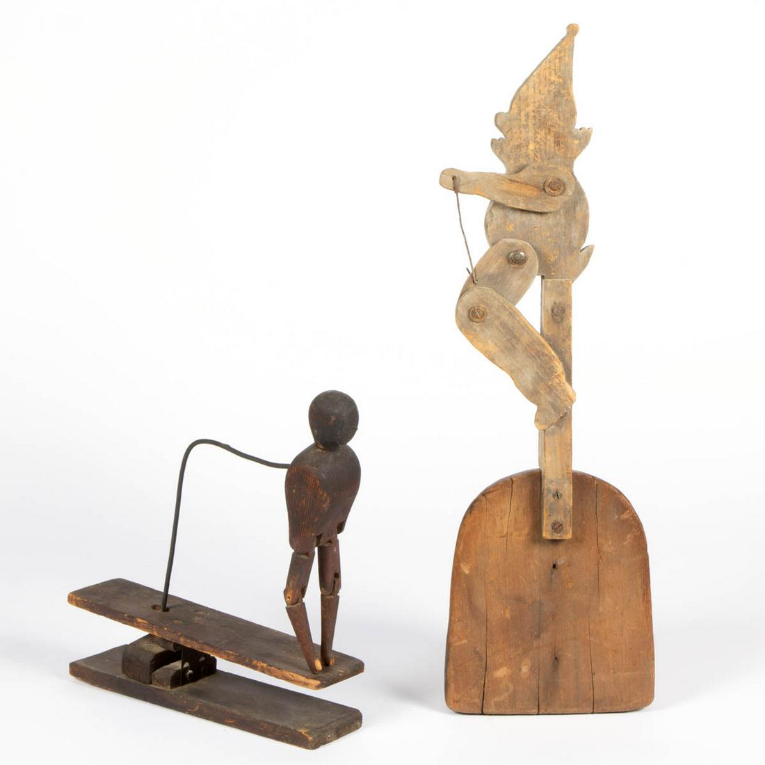 FOLK ART CARVED WHIRLIGIGS / JIGGERS, LOT OF TWO: FOLK ART CARVED WHIRLIGIGS / JIGGERS, LOT OF TWO, each in a dry natural surface. Late 19th/early 20th century. 10 1/2" and 21" HOA. Very good overall as-found condition, jester example with old pieces