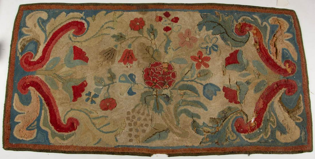 AMERICAN FOLK ART HOOKED HEARTH RUG: AMERICAN FOLK ART HOOKED HEARTH RUG, rectangular form featuring a floral design with scrolled corners and leaves, later applied burlap backing. Mid-19th century. 66" x 33". Fair overall as-found condi