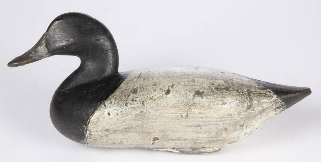 JAMES T. HOLLY (HAVRE DE GRACE, MARYLAND, 1849-1935),: JAMES T. HOLLY (HAVRE DE GRACE, MARYLAND, 1849-1935), ATTRIBUTED, CARVED AND PAINTED BLUEBILL DECOY, branded to the underside "H.P.S.", possibly for Harry P. Strasbaugh (Maryland, 1868-1930). Old repa