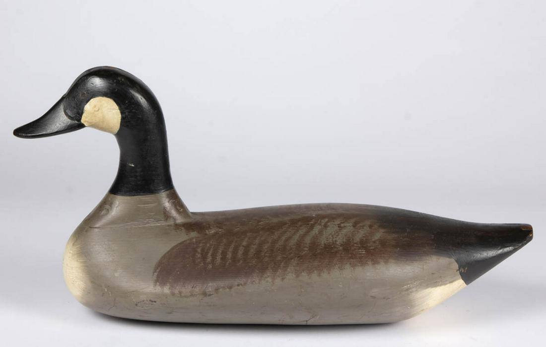 AMERICAN FOLK ART CARVED AND PAINTED CANADA GOOSE DECOY: AMERICAN FOLK ART CARVED AND PAINTED CANADA GOOSE DECOY, retaining likely original surface. First half 20th century. 10 1/2" HOA, 21" LOA. Very good overall condition with minor wear and cracks. Prove