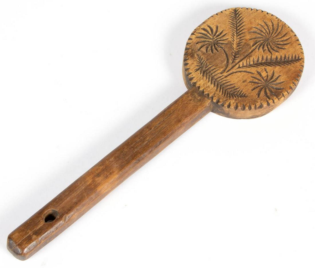 AMERICAN CARVED TREEN BUTTER PRINT: AMERICAN CARVED TREEN BUTTER PRINT, probably walnut, single-piece lollipop form with chamfered-edge square handle, front carved with pinwheel flowers design within a notched border, plain back. Dry na