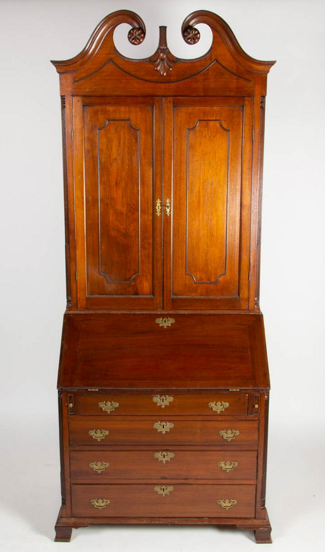 SHENANDOAH VALLEY OF VIRGINIA, CHIPPENDALE CARVED: SHENANDOAH VALLEY OF VIRGINIA, CHIPPENDALE CARVED WALNUT DESK AND BOOKCASE, two-piece construction, upper case with molded swan's neck pediment with floral rosettes centering a channel-molded finial p