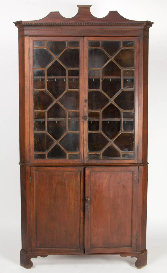 EASTERN VIRGINIA YELLOW PINE CHIPPENDALE CORNER: EASTERN VIRGINIA YELLOW PINE CHIPPENDALE CORNER CUPBOARD, two-piece construction, applied ogee-molded cornice with dental molding, above two geometrically glazed doors, over two doors, the whole raise