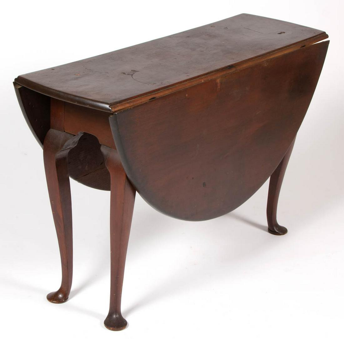 AMERICAN / BRITISH QUEEN ANNE MAHOGANY FALL-LEAF TABLE: AMERICAN / BRITISH QUEEN ANNE MAHOGANY FALL-LEAF TABLE, the rectangular rounded-edge top fitted with two demi-lune fall leaves, all raised on four cabriole legs ending in slipper feet. Old surface wit