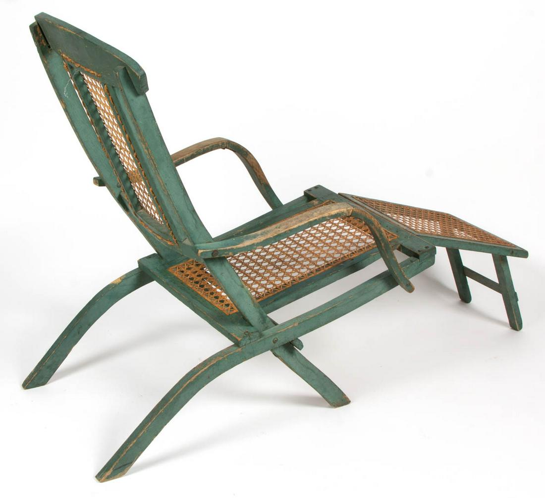 AMERICAN COUNTRY PANTED FOLDING DECK CHAIR: AMERICAN COUNTRY PANTED FOLDING DECK CHAIR, with later replaced seat. Retains an old green-painted surface. Late 19th/early 20th century. 35" H, 41" LOA. Very good overall visual condition, with areas
