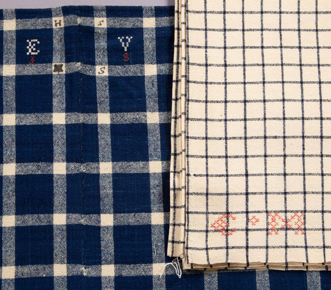 AMERICAN HOMESPUN WOOL BLANKETS, LOT OF TWO: AMERICAN HOMESPUN WOOL BLANKETS, LOT OF TWO, each two joined panels, comprising a white example with navy blue pattern featuring embroidered "C M" or "E M" initials to two corners with one also having