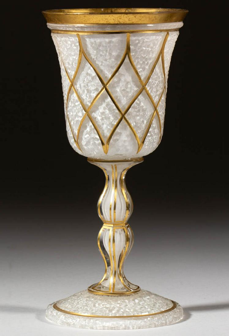 OVERSHOT GOBLET: OVERSHOT GOBLET, opaque white cased colorless with gilt decoration, lattice patterned bowl, applied hollow double knop panelled stem also with white casing. Probably Bohemia. 1860-1890. 8 1/8" H. Unda