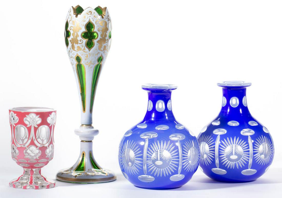 ASSORTED CUT-OVERLAY ARTICLES, LOT OF FOUR: ASSORTED CUT-OVERLAY ARTICLES, LOT OF FOUR, various colors, including a pair of double-overlay water bottles with sunburst motif, and a trumpet vase with Moorish windows and an arching rim. Bohemia an
