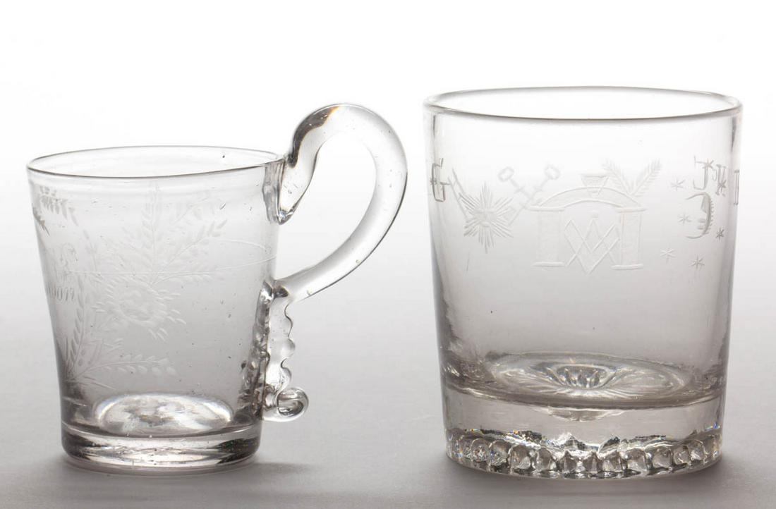 FREE-BLOWN AND ENGRAVED DRINKING ARTICLES, LOT OF TWO: FREE-BLOWN AND ENGRAVED DRINKING ARTICLES, LOT OF TWO, colorless, comprising a Masonic engraved tumbler showing a compass and arched flanked by the sun and moon, initials "F Mc C" and "M G" to the rev