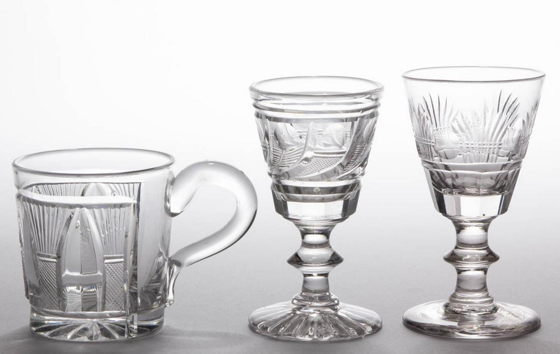 ASSORTED CUT GLASS ARTICLES, LOT OF THREE: ASSORTED CUT GLASS ARTICLES, LOT OF THREE, colorless, comprising a Sheaf of Wheat mug, a Sheaf of Wheat wine with roundels in between, and a Comet example. Pittsburgh area. 1825-1835. 2 3/4" H to 4 1/