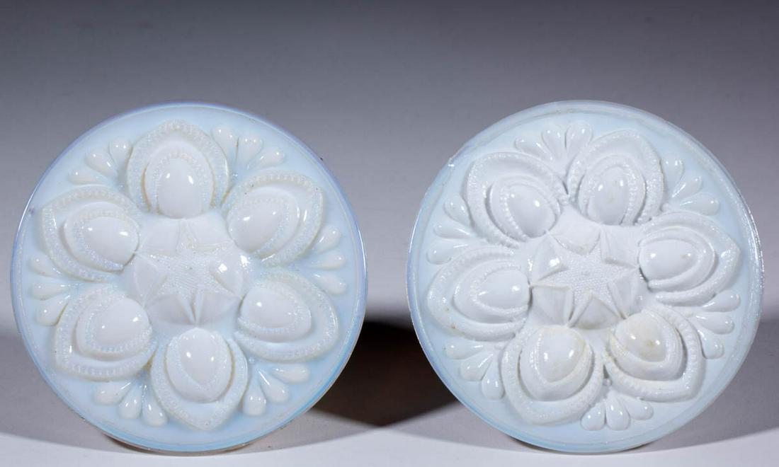 PRESSED ROSETTE PAIR OF CURTAIN PINS / TIE BACKS: PRESSED ROSETTE PAIR OF CURTAIN PINS / TIE BACKS, opaque white with some fiery opalescence to the edges, each circular, and each with original shank. Boston & Sandwich Glass Co. 1840-1870. 5" D. One u
