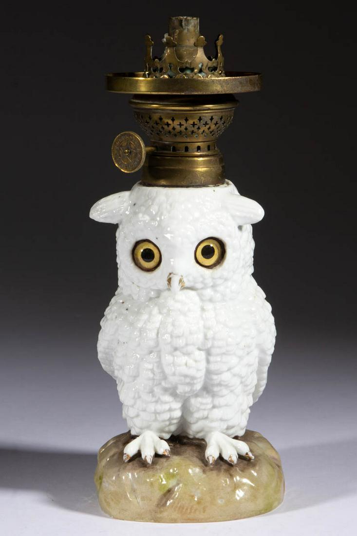 GERMAN ERNST BOHNE SOHNE PORCELAIN OWL FIGURAL: GERMAN ERNST BOHNE SOHNE PORCELAIN OWL FIGURAL MINIATURE LAMP, white ground with worn gilt-decorated highlights, standing on a molded circular natural-toned base, having yellow and black glass eyes, u