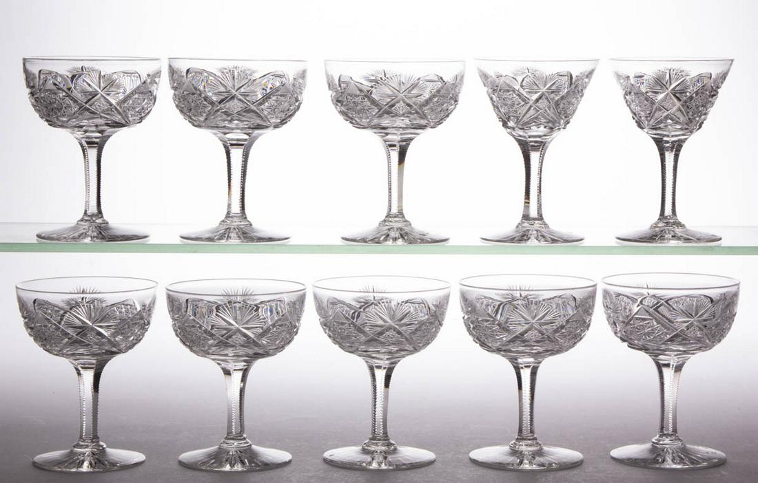 BRILLIANT CUT GLASS DRINKING ARTICLES, LOT OF TEN: BRILLIANT CUT GLASS DRINKING ARTICLES, LOT OF TEN, colorless, comprising eight champagnes and two wines, each having a matching diamond and sunburst pattern. Maker unverified. Late 19th/early 20th cen