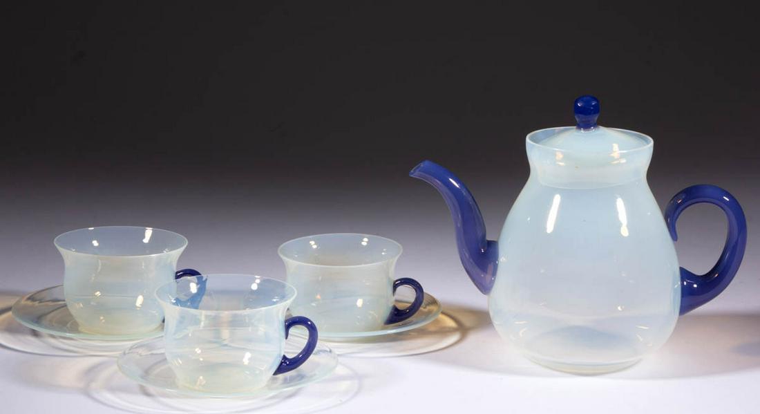 FRY FOVAL NO. 2005 ART GLASS SEVEN-PIECE TEA SET: FRY FOVAL NO. 2005 ART GLASS SEVEN-PIECE TEA SET, opalescent, comprising a teapot with matching cover, three tea cups, and three saucers, teapot and cups having Delft applications. H. C. Fry Glass Co.
