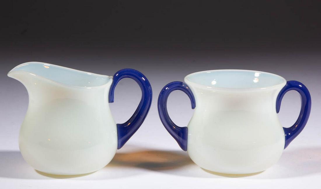 FRY FOVAL NO. 2000 ART GLASS CREAM AND SUGAR SET: FRY FOVAL NO. 2000 ART GLASS CREAM AND SUGAR SET, opalescent, comprising a creamer with an applied Delft handle, and a waisted sugar with applied Delft double handles. H. C. Fry Glass Co. First half 2