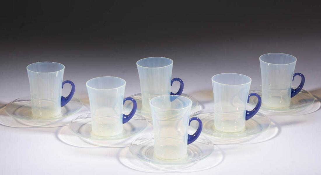 FRY FOVAL ART GLASS TALL TEA CUPS AND SAUCERS, LOT OF: FRY FOVAL ART GLASS TALL TEA CUPS AND SAUCERS, LOT OF 12, opalescent, each tea cup having an applied Delft handle. H. C. Fry Glass Co. First half 20th century. Tea cup: 3 1/2" H. Saucers: 5 1/2" to 5