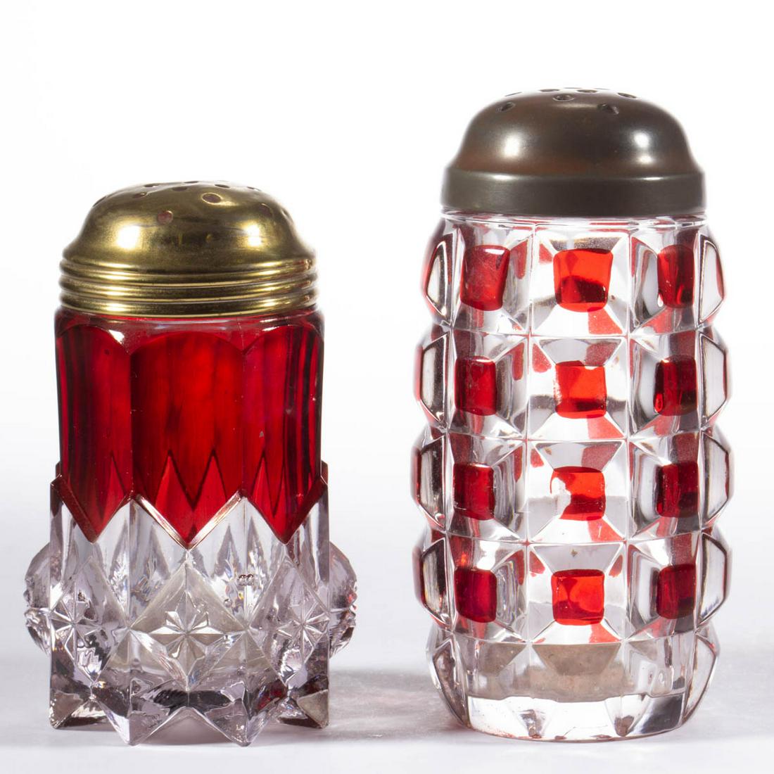 ASSORTED EAPG - RUBY-STAINED SUGAR SHAKERS, LOT OF TWO: ASSORTED EAPG - RUBY-STAINED SUGAR SHAKERS, LOT OF TWO, colorless, comprising a Duncan Late Block, and an O'Hara Diamond, each having a period lid. Various makers. Fourth quarter 19th/first quarter 20