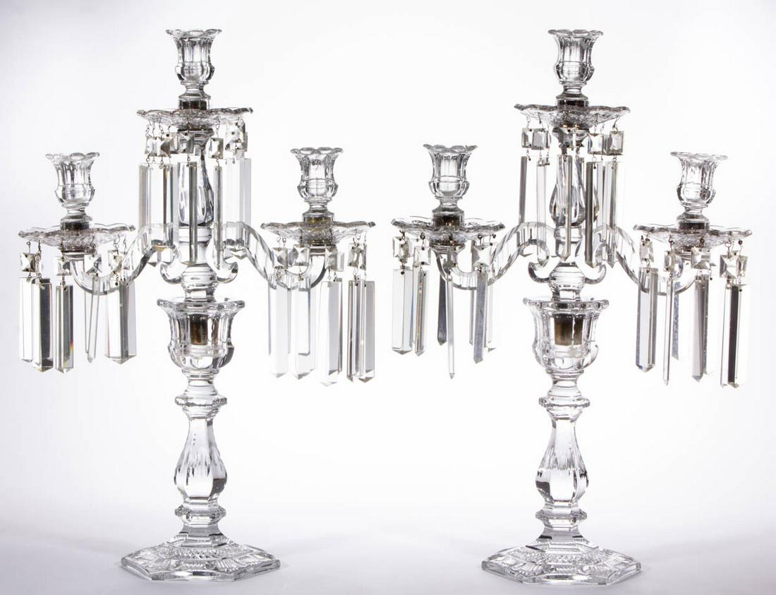 CUT CRYSTAL GLASS PAIR OF THREE-ARM CANDELABRAS: CUT CRYSTAL GLASS PAIR OF THREE-ARM CANDELABRAS, colorless, each having a tall hexagonal standard with matching waisted three-arm inserts supporting three sockets and matching bobeches, period coffin-