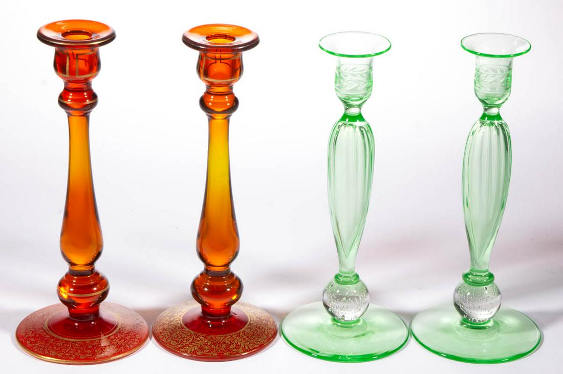 ASSORTED GLASS CANDLESTICKS, LOT OF FOUR: ASSORTED GLASS CANDLESTICKS, LOT OF FOUR, comprising a pair of amberina Tiffin examples, and a pair of green Pairpoint controlled-bubble examples. Various makers. First half 20th century. 9 7/8" to 10