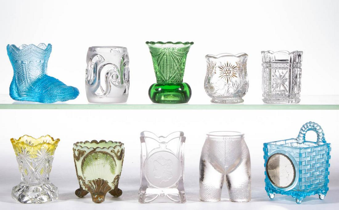 ASSORTED PRESSED GLASS TOOTHPICK HOLDERS, LOT OF TEN: ASSORTED PRESSED GLASS TOOTHPICK HOLDERS, LOT OF TEN, various makers, including a U.S. Coin, a Geneva, an amber-stained Shoshone, and a Basket with frontal mirror. Various makers. Fourth quarter 19th/