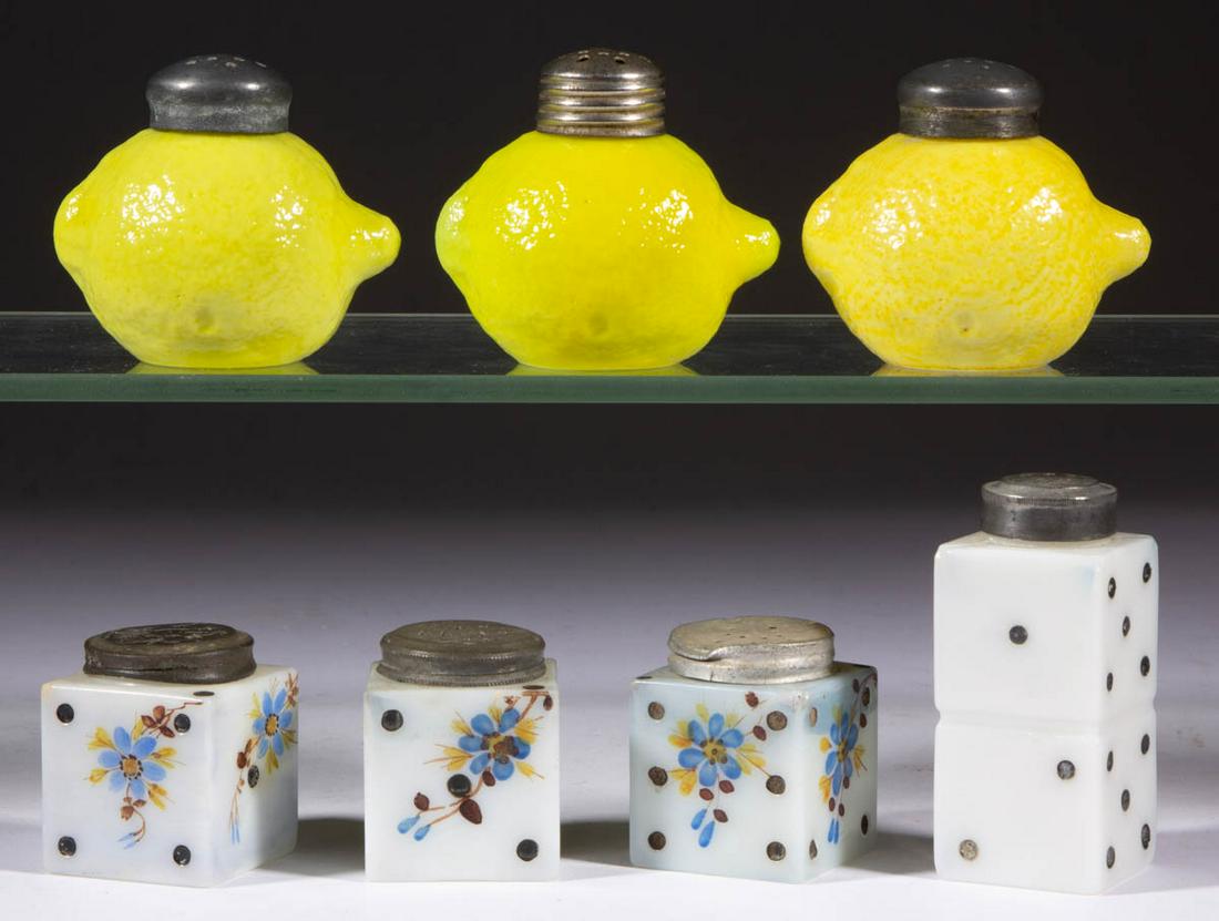 ASSORTED FIGURAL GLASS SALT AND PEPPER SHAKERS, LOT OF: ASSORTED FIGURAL GLASS SALT AND PEPPER SHAKERS, LOT OF SEVEN, comprising four dice with one having double-stacked form, and three lemons, each having a period lid. Various makers. Fourth quarter 19th/