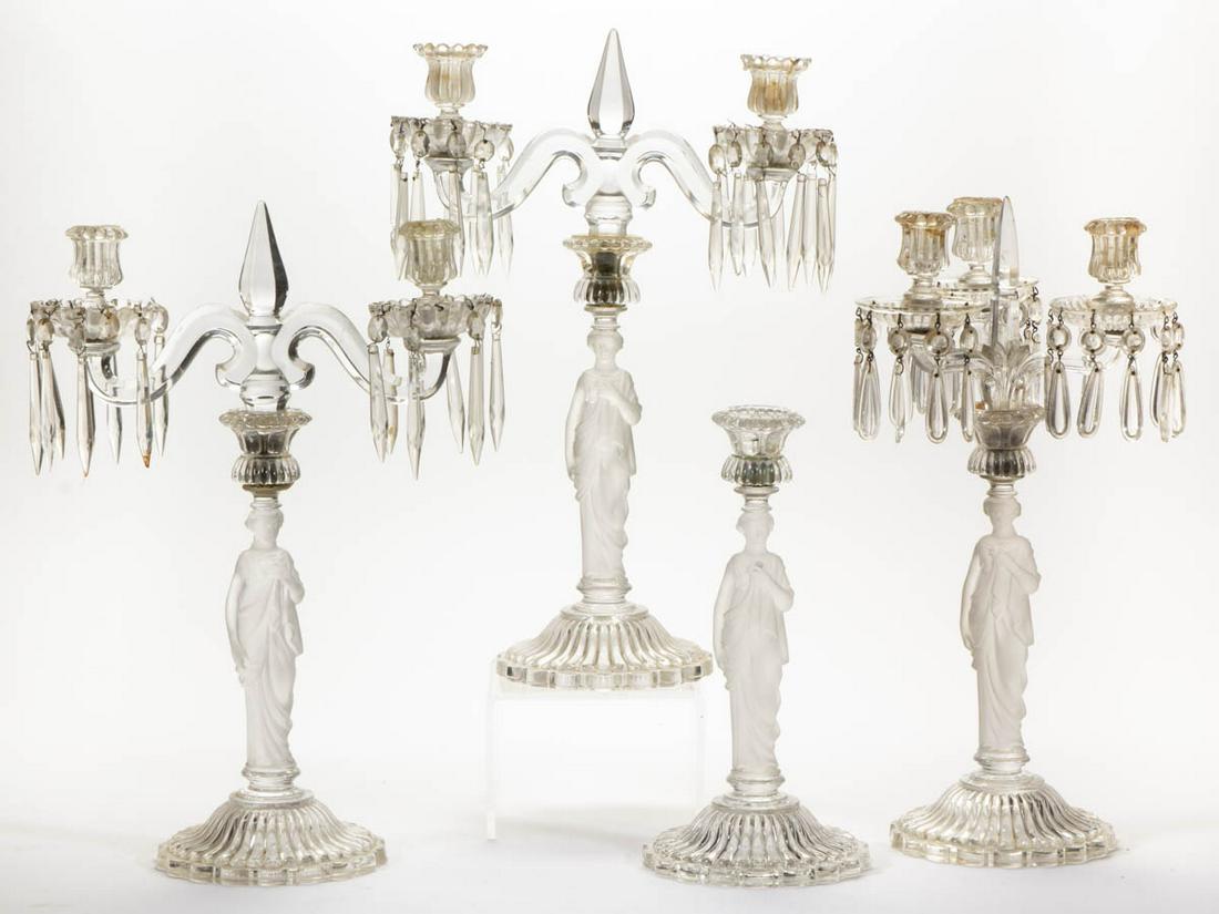 BACCARAT FROSTED MADONNA CANDLESTICKS / CANDELABRAS,: BACCARAT FROSTED MADONNA CANDLESTICKS / CANDELABRAS, LOT OF FOUR, colorless, each piece having a pressed figural Madonna standard raised on a ribbed base with scallop-and-point foot, comprising a cand