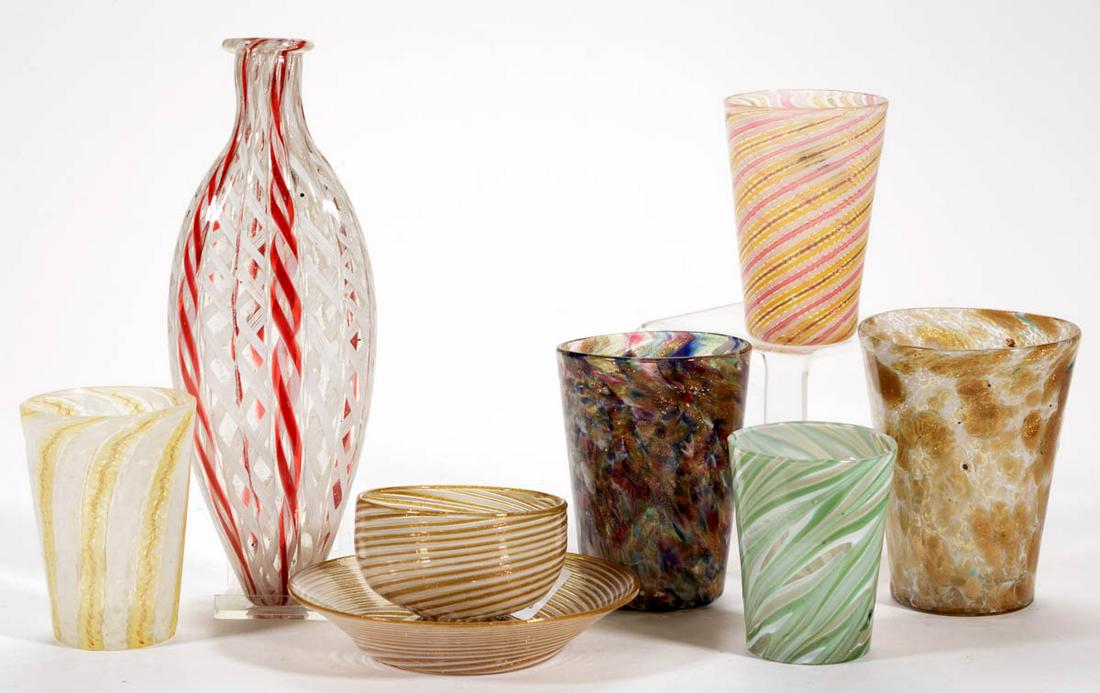 ASSORTED MURANO GLASS ARTICLES, LOT OF SEVEN: ASSORTED MURANO GLASS ARTICLES, LOT OF SEVEN, colorless with polychrome twist canes and spatter, comprising five tumblers, a flask, and a cup and saucer set. Various makers. Fourth quarter 19th/first
