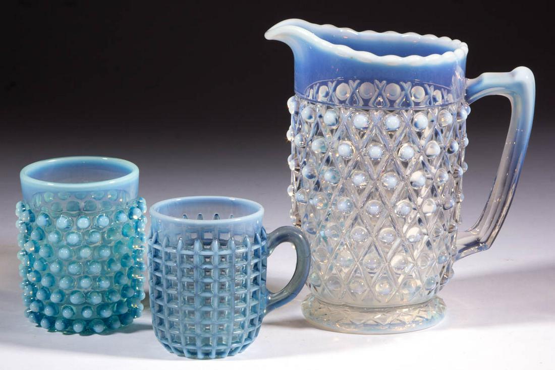 ASSORTED PRESSED OPALESCENT ARTICLES, LOT OF THREE: ASSORTED PRESSED OPALESCENT ARTICLES, LOT OF THREE, colorless opalescent and blue opalescent, comprising a Hobnail milk pitcher with embossed Diamond-Quilt pattern, a Beatty Waffle mug, and a Hobnail 