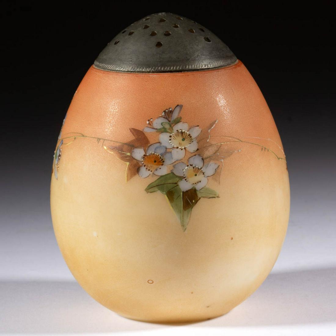 MT. WASHINGTON EGG SUGAR SHAKER: MT. WASHINGTON EGG SUGAR SHAKER, opaque white with fired on Burmese ground and polychrome-enamel decoration, floral decoration, period lid. Mt. Washington Glass Co. Fourth quarter 19th century. 4 1/4"