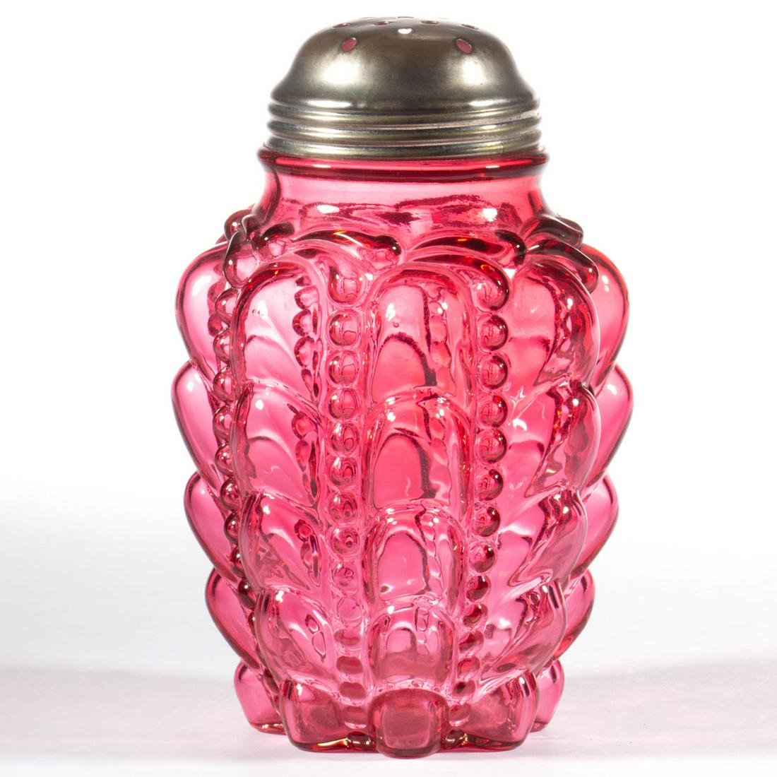 GUTTATE SUGAR SHAKER: GUTTATE SUGAR SHAKER, cased cranberry, period lid. Consolidated Lamp & Glass Co. Fourth quarter 19th century. 5 5/8" H. Undamaged. Literature: Parallels Murray - Fostoria, Ohio Glass II, p. 141, fig. 