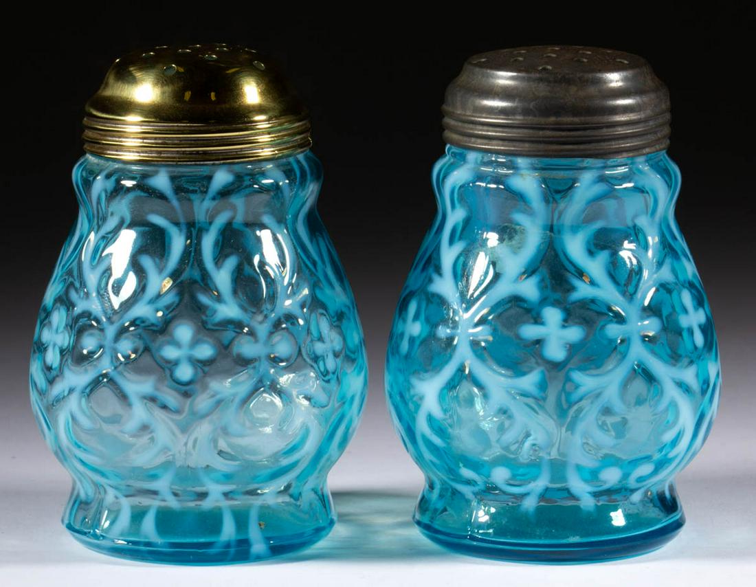 OPALINE BROCADE / SPANISH LACE PAIR OF SUGAR SHAKERS: OPALINE BROCADE / SPANISH LACE PAIR OF SUGAR SHAKERS, blue opalescent, each having a period lid. Northwood Glass Co. Pattern introduced in 1899. 4 3/4" H.One undamaged; other having a single flake to