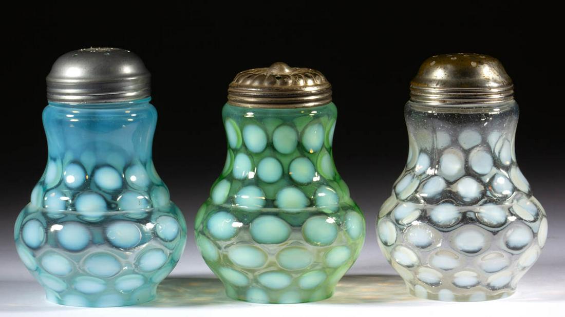 COINSPOT - BULBOUS-BASE SUGAR SHAKERS, LOT OF THREE: COINSPOT - BULBOUS-BASE SUGAR SHAKERS, LOT OF THREE, colorless opalescent, green opalescent, and blue opalescent, each having a period lid. H. Northwood Co. Early 20th century. 4 7/8" to 5" HOA. Undam
