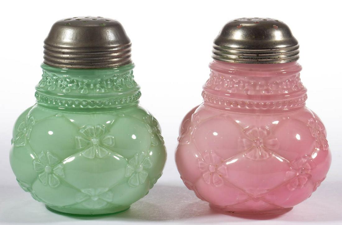 QUILTED PHLOX SUGAR SHAKERS, LOT OF TWO: QUILTED PHLOX SUGAR SHAKERS, LOT OF TWO, cased pink and cased opaque green, each having a period lid. Northwood Glass Co. Fourth quarter 19th century. 4 3/4" H. Undamaged. Each having some expected li