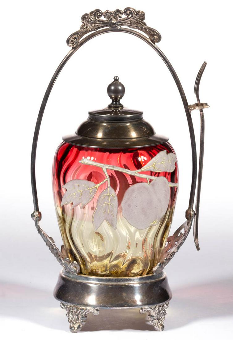 AMBERINA ENAMEL-DECORATED MOIRE-OPTIC PICKLE CASTER: AMBERINA ENAMEL-DECORATED MOIRE-OPTIC PICKLE CASTER, barrel form, factory-polished rim, fitted in a quadruple-plated stand marked for "EMPIRE MFG. CO.", silver-plated cover unmarked, including fork. M