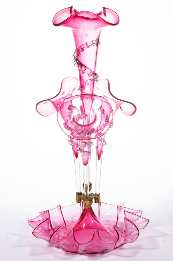 VICTORIAN CRANBERRY GLASS EPERGNE: VICTORIAN CRANBERRY GLASS EPERGNE, fitted with four vases including a tall central trumpet vase, each having applied colorless rigaree. Fourth quarter 19th century. 19" HOA, 10" DOA base. Nearly undam