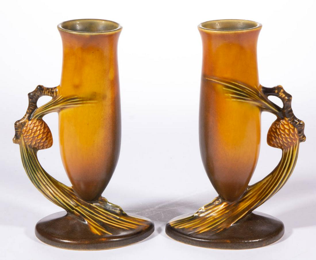 ROSEVILLE BROWN "PINE CONE" ART POTTERY PAIR OF VASES: ROSEVILLE BROWN "PINE CONE" ART POTTERY PAIR OF VASES, each having a molded pine cone and branch handle with golden brown glaze. Marks include incised and inked "4" to underside. Roseville Pottery Com