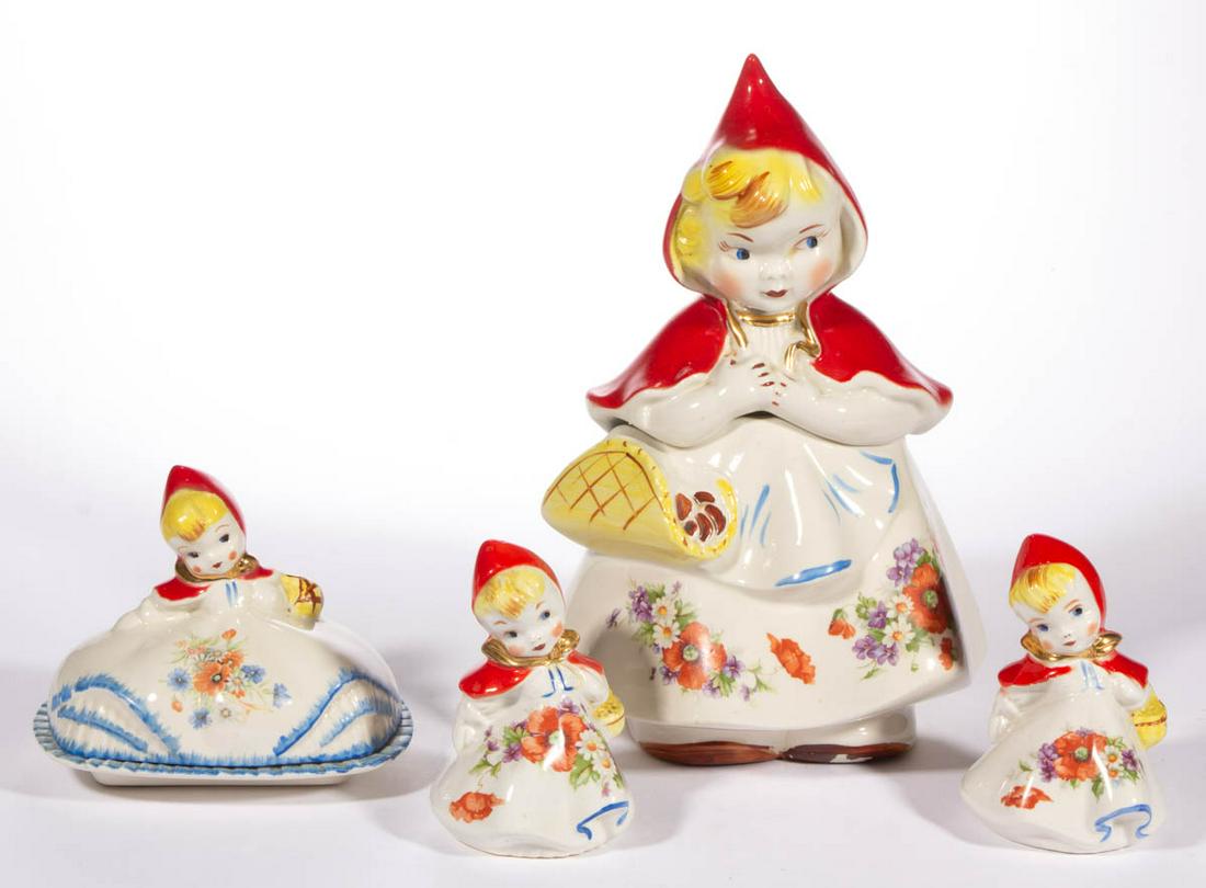 HULL "LITTLE RED RIDING HOOD" ART POTTERY FIGURAL TABLE: HULL "LITTLE RED RIDING HOOD" ART POTTERY FIGURAL TABLE ARTICLES, LOT OF FOUR, comprising a cookie jar, a salt and pepper set, and a covered butter dish, each in the form of a blond-haired girl wearin