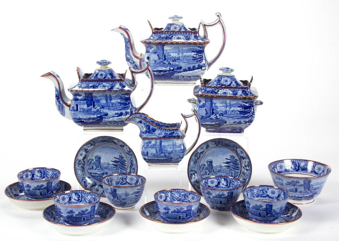 ENGLISH STAFFORDSHIRE PEARL WARE BLUE TRANSFER-PRINTED: ENGLISH STAFFORDSHIRE PEARL WARE BLUE TRANSFER-PRINTED CERAMIC 17-PIECE TEA SET, each featuring two fishermen on bank with castle ruins in background and pink luster accents, comprising two teapots, a