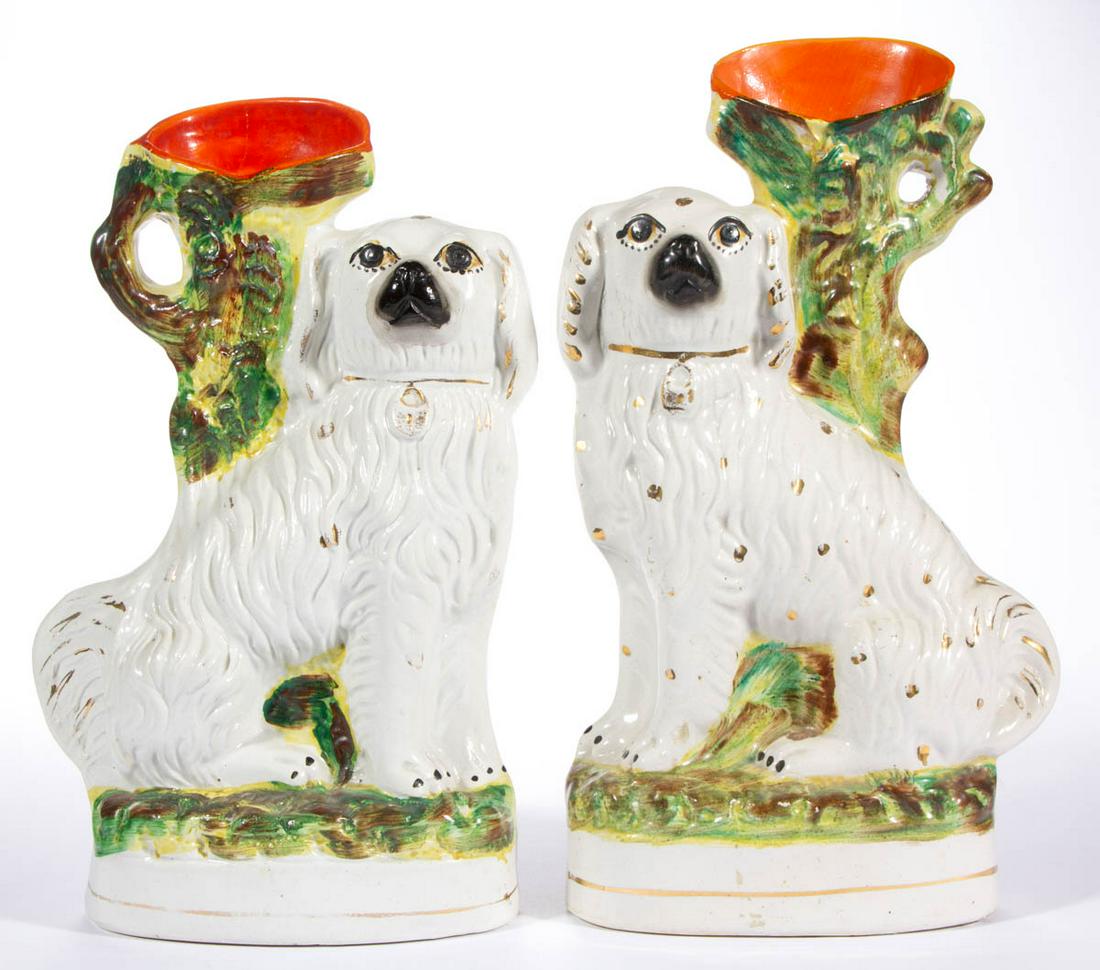 ENGLISH STAFFORDSHIRE HAND-PAINTED CERAMIC SPANIEL /: ENGLISH STAFFORDSHIRE HAND-PAINTED CERAMIC SPANIEL / DOG FIGURAL SPILL VASE PAIR, each seated on oval base with locket collars, molded tree-like vase to back, and bold polychrome enamel decorations wi