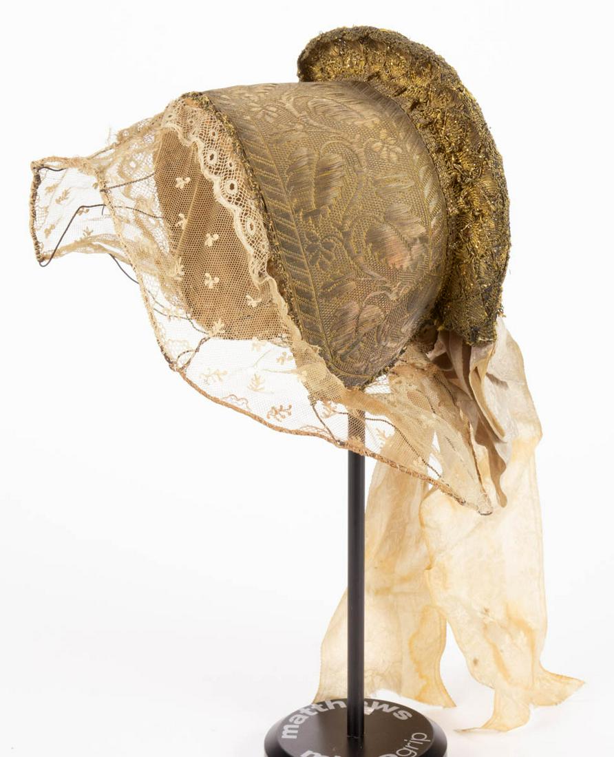 GERMAN / AUSTRIAN GOLDHAUBE FOLK HEADDRESS: GERMAN / AUSTRIAN GOLDHAUBE FOLK HEADDRESS, bonnet made of gilt-thread lace with sequins and gilt-foil, featuring an intricate foliate design to back of cap with three glass stones, front of cap cover
