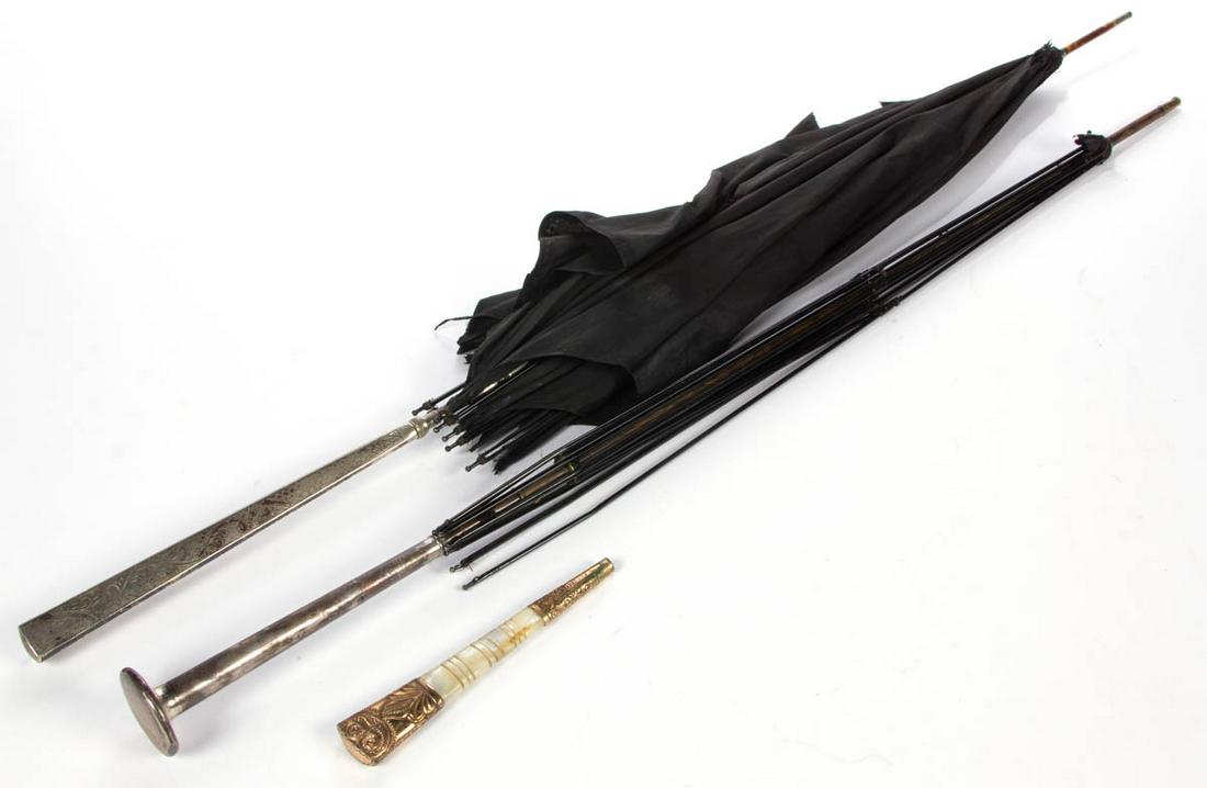 ANTIQUE STERLING SILVER-HANDLED UMBRELLAS / PARASOLS,: ANTIQUE STERLING SILVER-HANDLED UMBRELLAS / PARASOLS, LOT OF TWO, comprising one having black canopy and handle with engraved decoration, and the other with handle by Gorham Mfg. Co. Each marked "STER